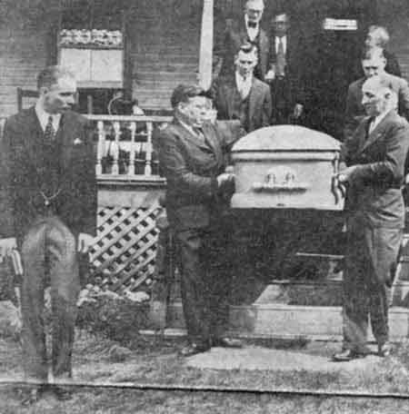 Pallbearers carry W.B. Wilson's casket